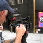Dave filming a storefront in New York City
