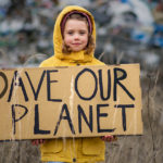 Child holding "Dave Our Planet" sign